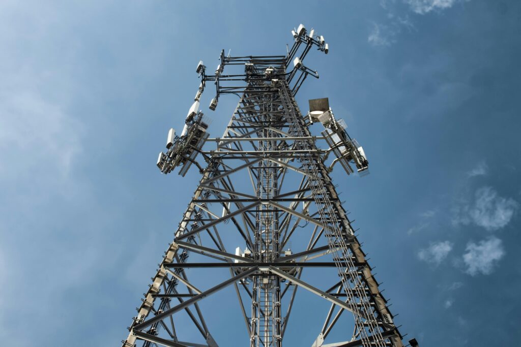 pexels-photo-7862565-7862565 A low-angle shot of a tall metal communications tower with multiple antennas against a clear blue sky.